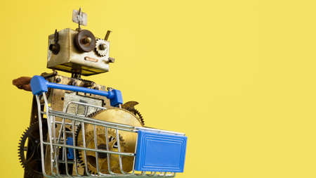 Robot with shopping cart and mechanical parts. Sales and promotion.の写真素材