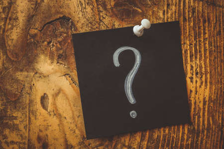 Pinned dark sticker and question mark on it.の写真素材