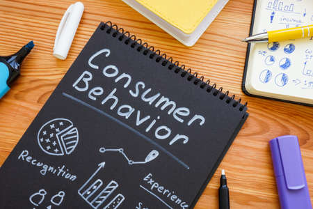 Marks about consumer behavior and notepad with charts.の写真素材