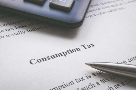 Info about consumption tax and a pen.の写真素材