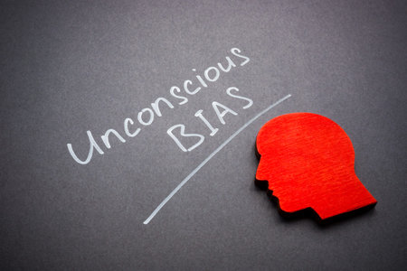 Sign unconscious bias on dark surface and head shape.