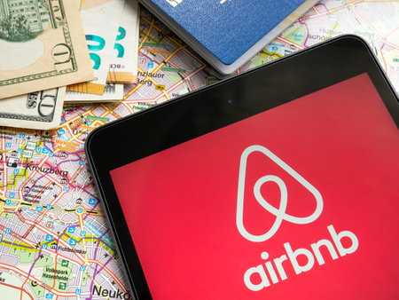 KYIV, UKRAINE - July 21, 2022. Tablet with Airbnb logo and a map.のeditorial素材