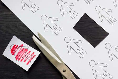 Cancel culture concept. A figurine cut off from a sheet.の写真素材