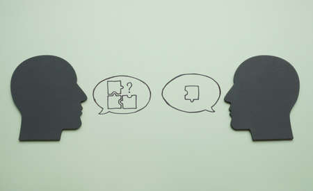 Heads and puzzles in speech bubbles. Leadership and problems solving concept.の写真素材