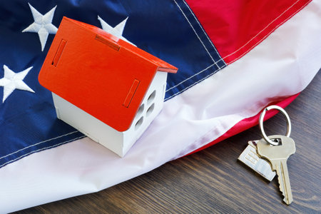 USA flag, house model and keys. VA loan concept.の写真素材