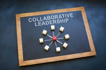 Wooden cubes on the blackboard and sign collaborative leadership.の写真素材