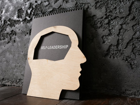 Head and notepad with sign self-leadership near wall.の写真素材