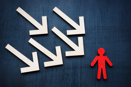 Assertiveness and resilience concept. Arrows and red figurine.の写真素材