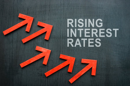 Inscription rising interest rates and red arrows.の写真素材