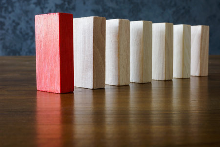 Charismatic leadership concept. Wooden blocks and one red in front.の写真素材