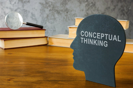 Conceptual thinking inscription on the head and books near.の写真素材