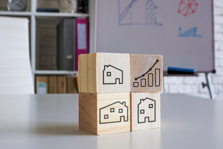 Real estate investment concept. Wooden cubes with houses and chart.の写真素材