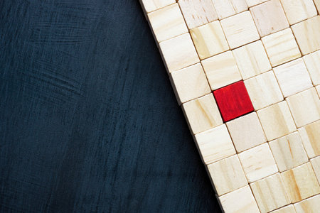 Wooden cubes and one red as a symbol of uniqueness and individuality.の写真素材