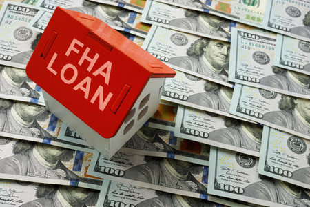 FHA loan concept. The house model stands on cash.の写真素材