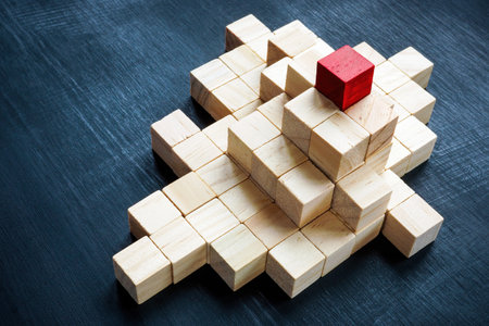 Pyramid of cubes and one red on top. The concept of leadership, success and company hierarchy.の写真素材
