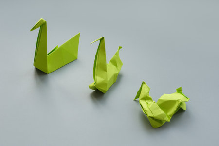 Paper swans and two dented as a symbol of burnout and stress.の写真素材