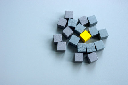 Be different and unique concept. Yellow cube surrounded by gray ones.の写真素材