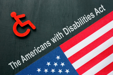 ADA or The Americans with Disabilities Act concept. Disabled person sign and USA flag.の写真素材