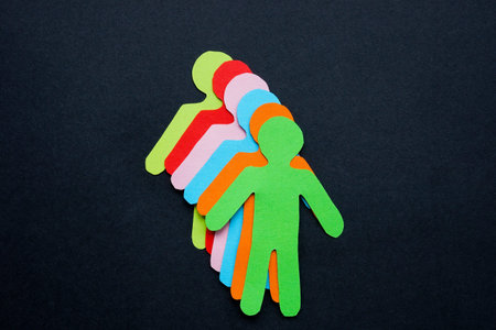Figures of people from colored paper as a symbol of diversity.