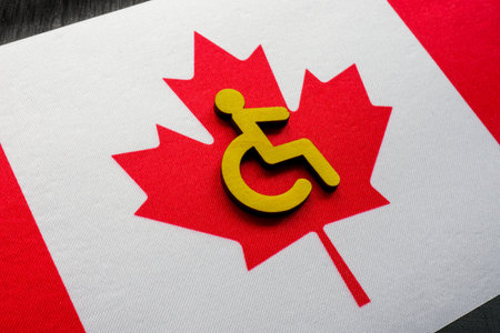 Flag of Canada and sign of a person with a disability. Accessible Canada act.の写真素材