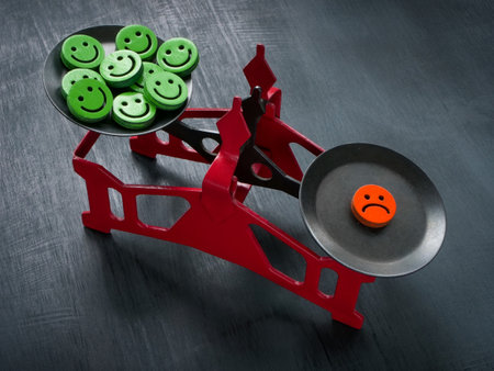 Scales with happy emoticons and sad. Negativity Bias concept.の写真素材