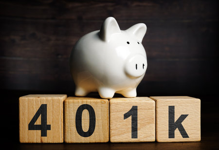 Piggy bank on the wooden cubes with sign 401k. Retirement plan concept.の写真素材