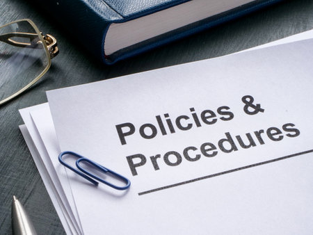 Documents about policies and procedures are on the table.の写真素材