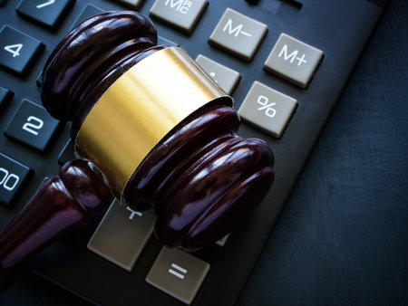 The gavel lies on the calculator as a concept of economic crimes and tax evasion.