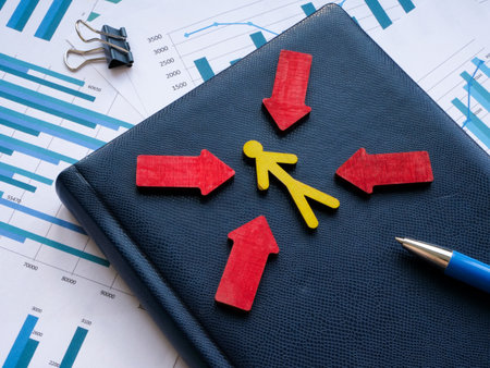 Customer focus concept. Figure with arrows and blue notepad on the papers.の写真素材