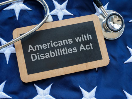 Sign with the inscription Americans with Disabilities Act ADA on the US flag.の写真素材