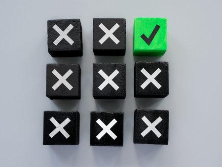 Black cubes and one green as concept for errors and correct answer or solution.