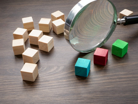 Wooden cubes and magnifying glass. Looking for talent. Recognition of skills abilities.の写真素材