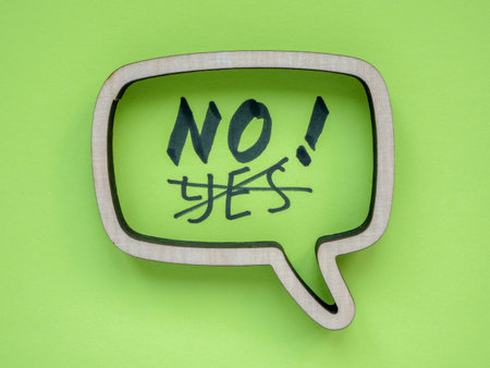 Learn to say no concept. Wooden speech bubble with and crossed out Yes.の写真素材