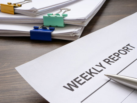 Weekly report and stack of papers.の写真素材