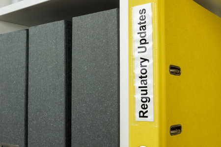 Folder with label regulatory updates on the shelf.の写真素材