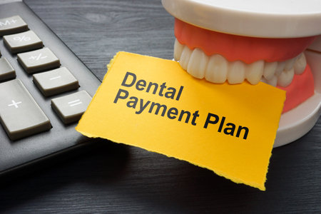 Dental payment plan. Calculator and jaws holding a sheet.の写真素材