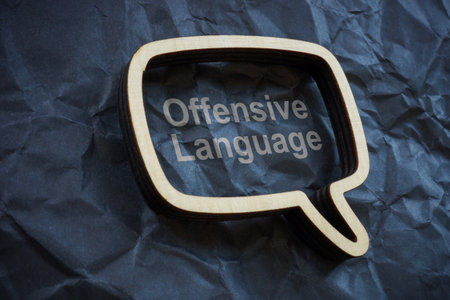 Offensive language concept. Speech bubble on crumpled paper.の写真素材