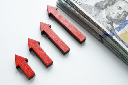 Growing graph of arrows and cash as a symbol of personal savings and income.