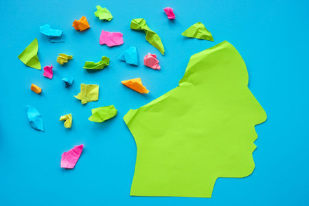 Mindfulness, positive thinking and mental health. Paper head with colored pieces of paper.
