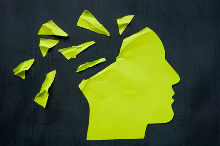 Paper head torn as a concept for memory and mental health problems.の写真素材