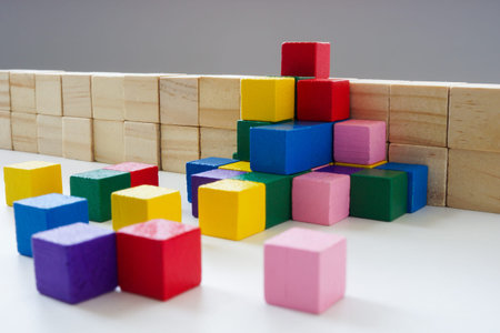 Allyship and teamwork concept. Colored cubes overcome the obstacle.