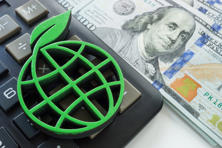 Financial sustainability concept. Green globe, calculator and money.