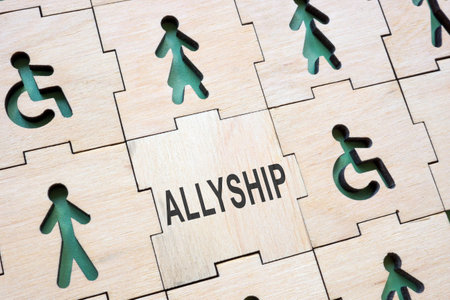 Puzzle with different figures and a word allyship.の写真素材