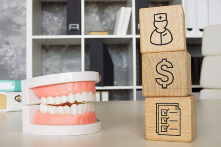 Jaw model and cubes as a concept of dental insurance.