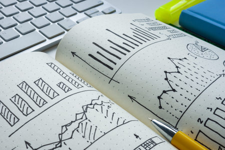 Close-up of a notebook with drawn business graphs as a symbol of financial planning.