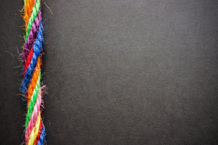 Colorful ropes twisted together. Symbolize strength and collaboration. Empty space.