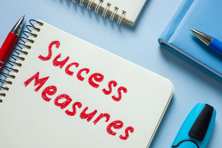 A notebook labeled success measures. Goal setting and tracking achievementsの写真素材
