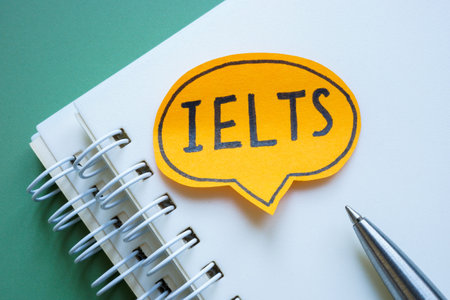 Notebook and speech bubble with IELTS. Exam preparation concept.の写真素材
