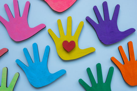 Colorful hands and a heart symbolizing love and diversity in community.の写真素材