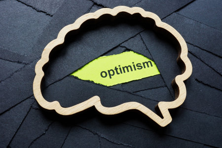Brain with black ribbons and the word optimism. Mental health recovery.の写真素材